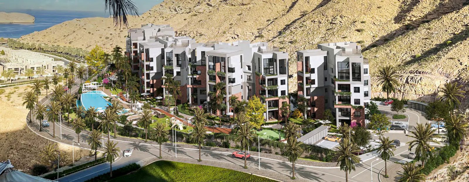 Zen Residences Muscat Bay — five buildings and the pool seen from the hillside