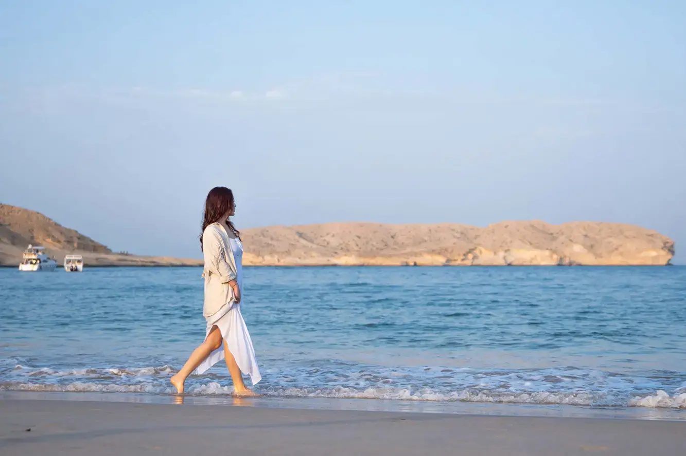 Walking along the shore of the Gulf of Oman at Muscat Bay
